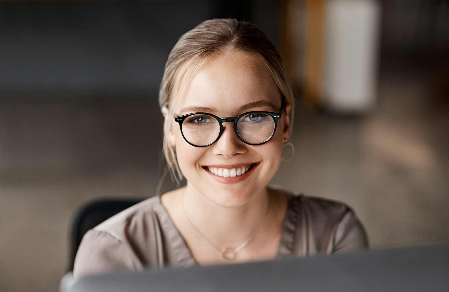 Shot of an attractive young businesswoman sitting alone in the office and using her computer